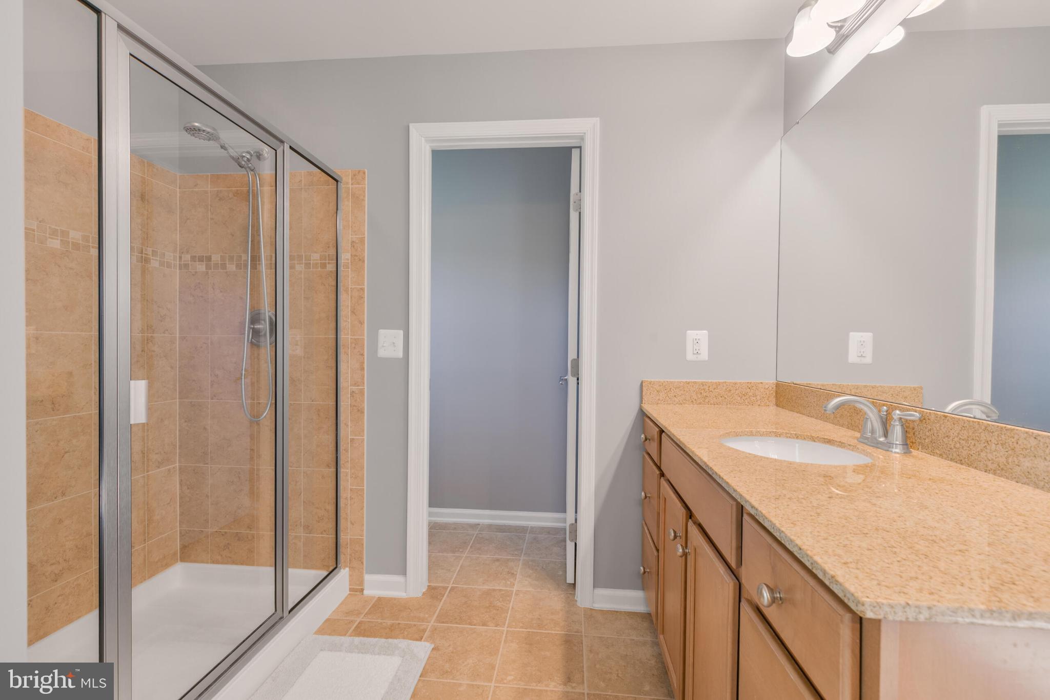 40652 Banshee Drive Leesburg, VA 20175 - Photo 31 of 51 a bathroom with a granite countertop sink and a mirror