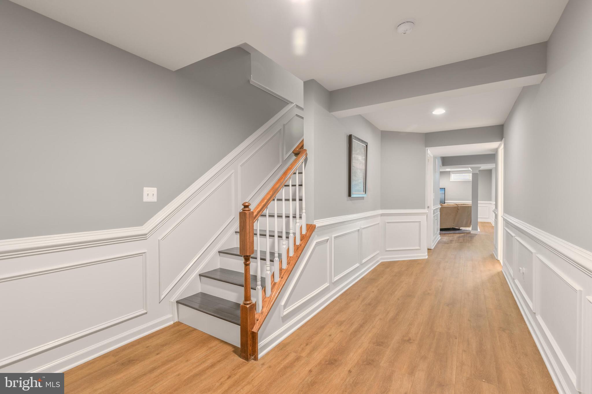 40652 Banshee Drive Leesburg, VA 20175 - Photo 33 of 51 a view of a hallway with wooden floor and staircase
