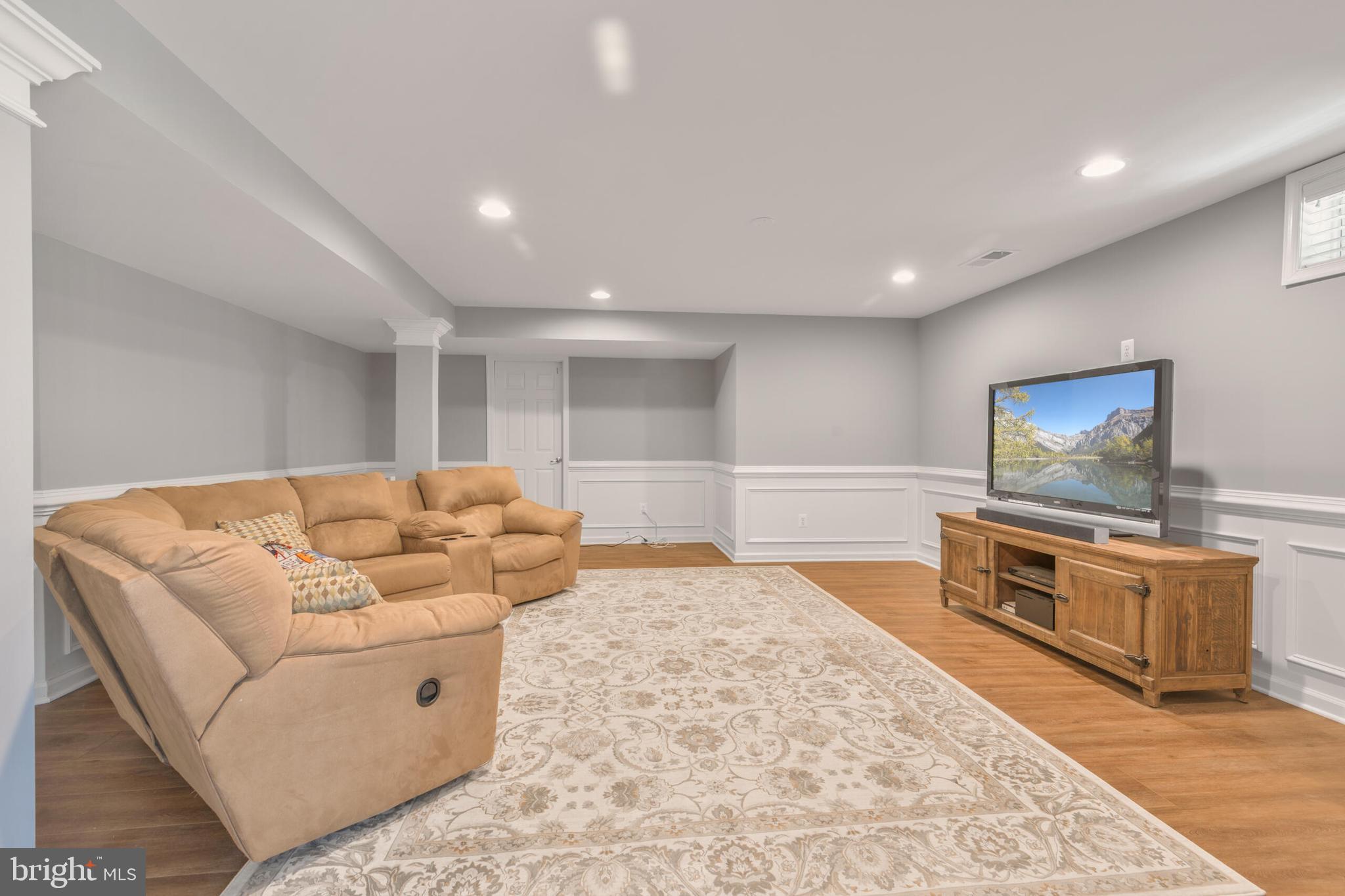 40652 Banshee Drive Leesburg, VA 20175 - Photo 36 of 51 a living room with furniture and a flat screen tv