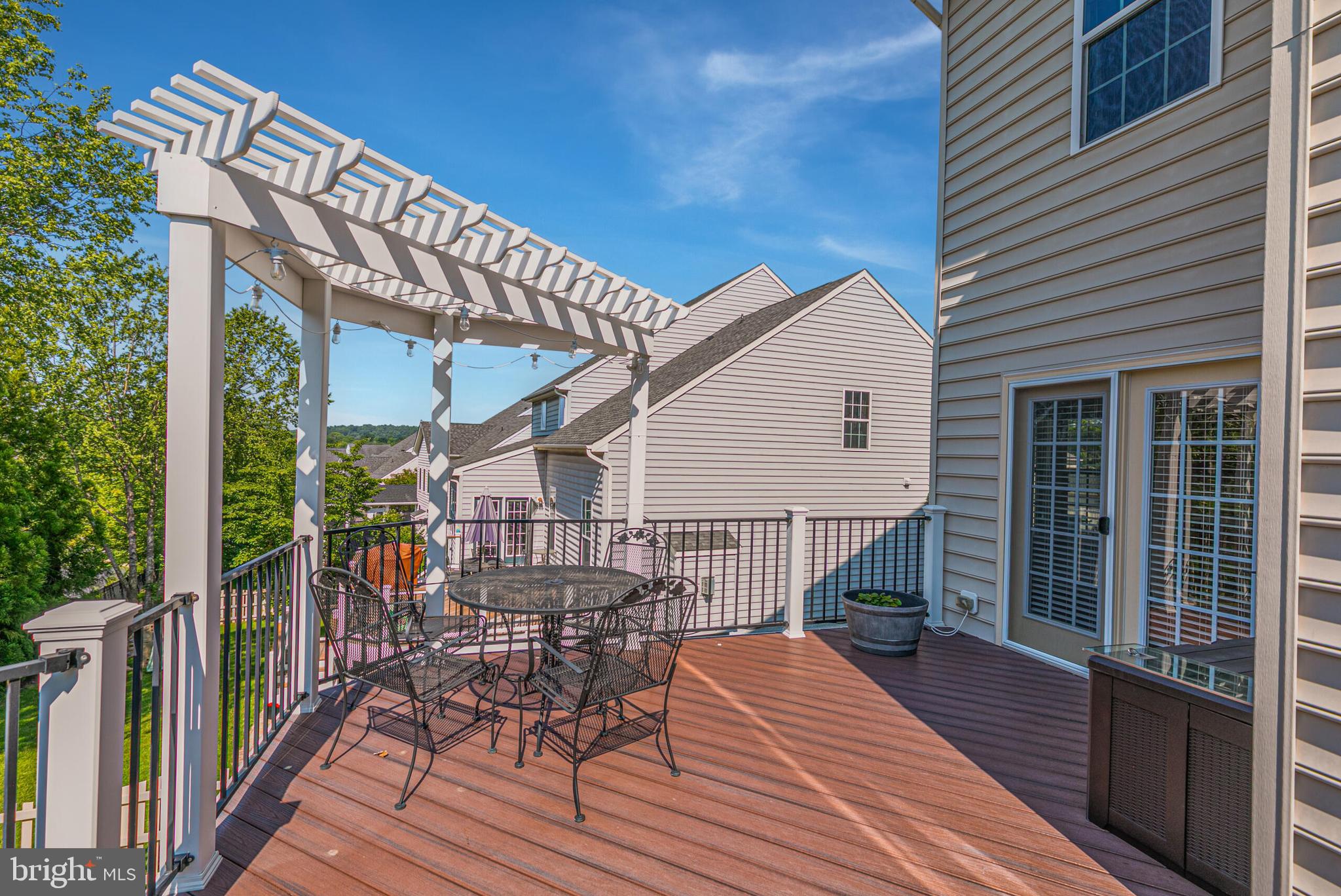 40652 Banshee Drive Leesburg, VA 20175 - Photo 41 of 51 a view of a house with a wooden deck and furniture