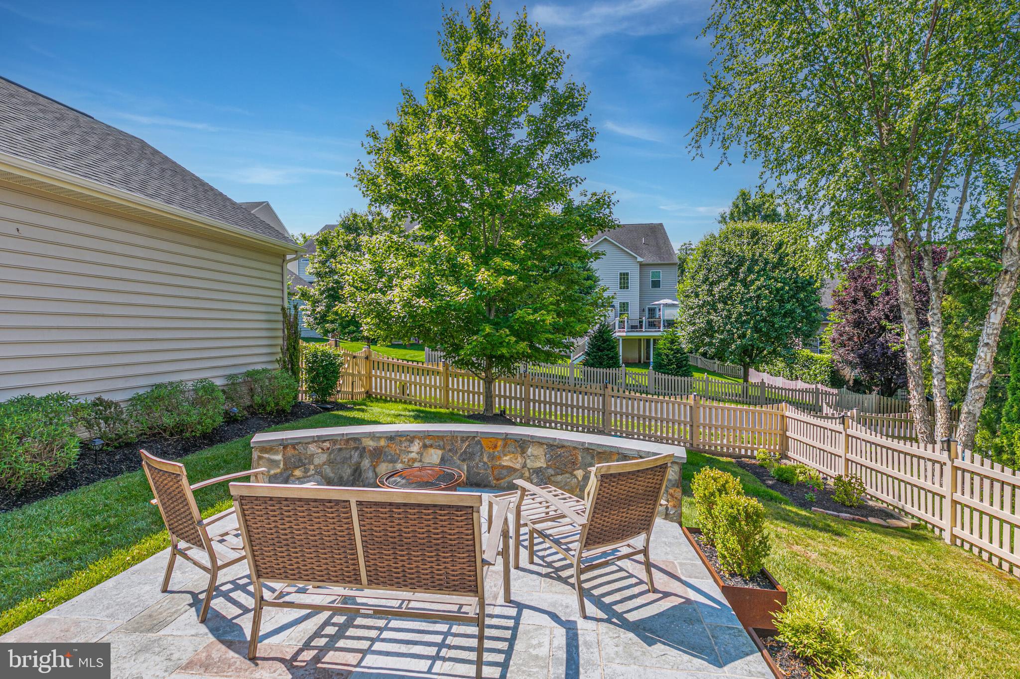 40652 Banshee Drive Leesburg, VA 20175 - Photo 46 of 51 a view of backyard with seating space and trees in the background