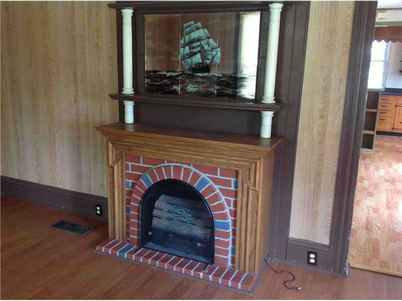 741 South State Line Road Sharon, PA 16146 - Photo 5 of 12 Living Room. An electric fireplace, with a built-in brick surround and mantel, highlights the living room.