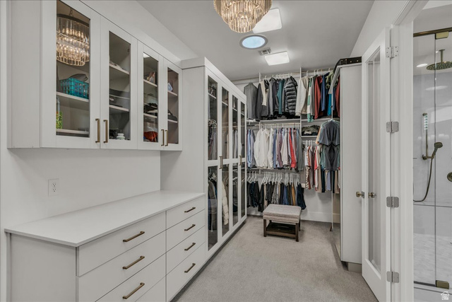 2608 Canyon Ridge Drive St. George, UT 84770 - Photo 39 of 86 Spacious primary closet featuring custom cabinetry, integrated shelving, and glass-front upper storage