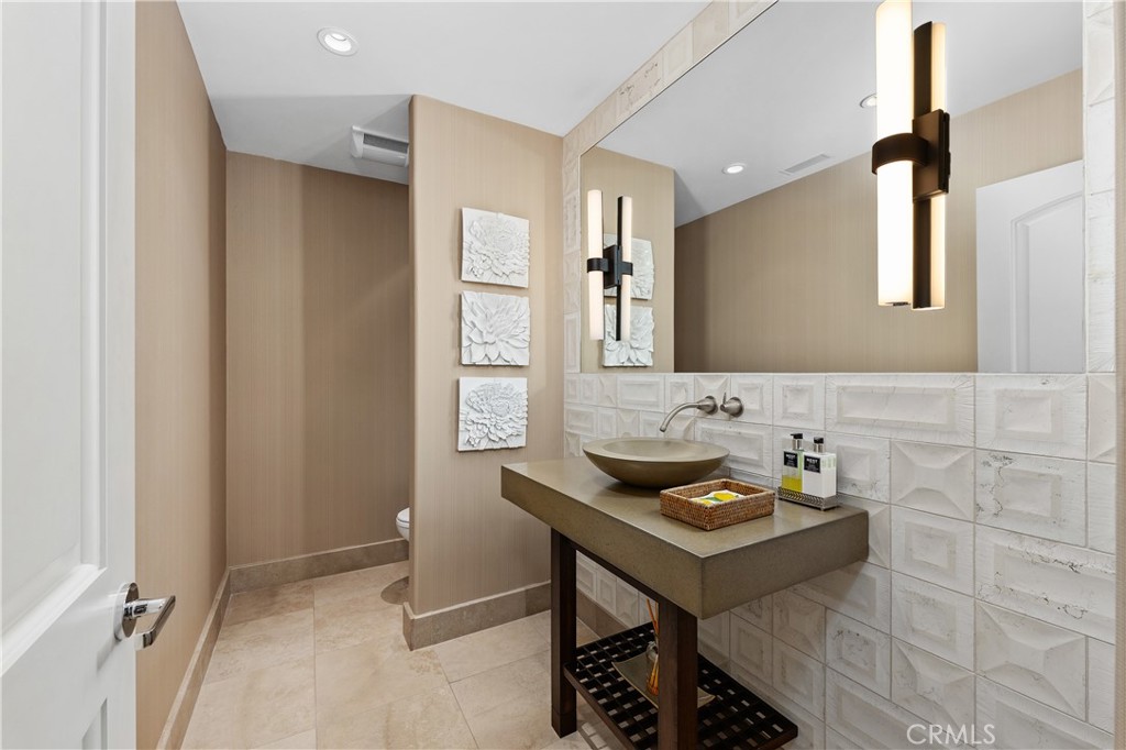 6533 Lago Lindo Rancho Santa Fe, CA 92067 - Photo 38 of 57 a bathroom with a sink and a mirror