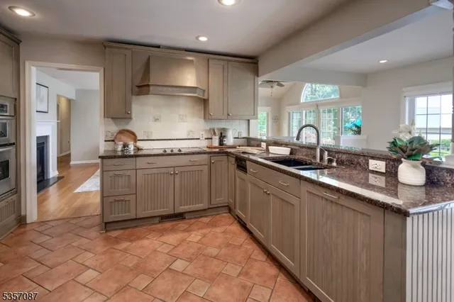 a kitchen with stainless steel appliances a sink stove and cabinets