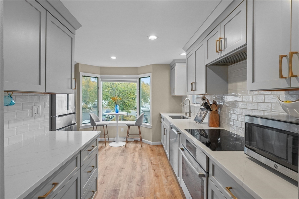 a kitchen with stainless steel appliances granite countertop a stove and a sink
