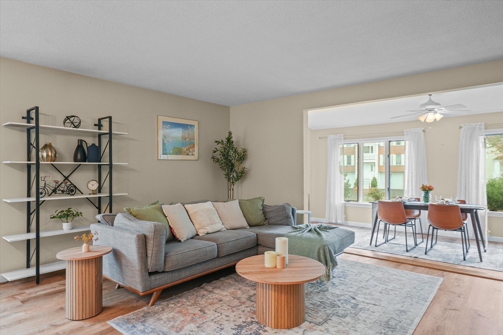 37 Constitution Lane, Unit 12 Danvers, MA 01923 - Photo 13 of 38 a living room with furniture a rug and a large window