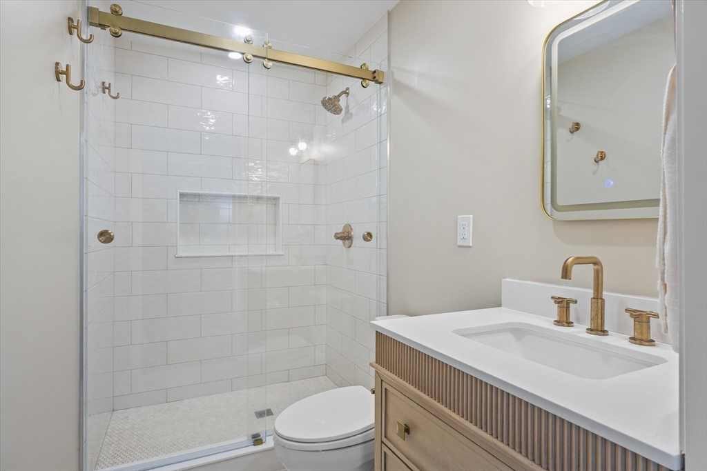 37 Constitution Lane, Unit 12 Danvers, MA 01923 - Photo 19 of 38 a bathroom with a sink a toilet and shower