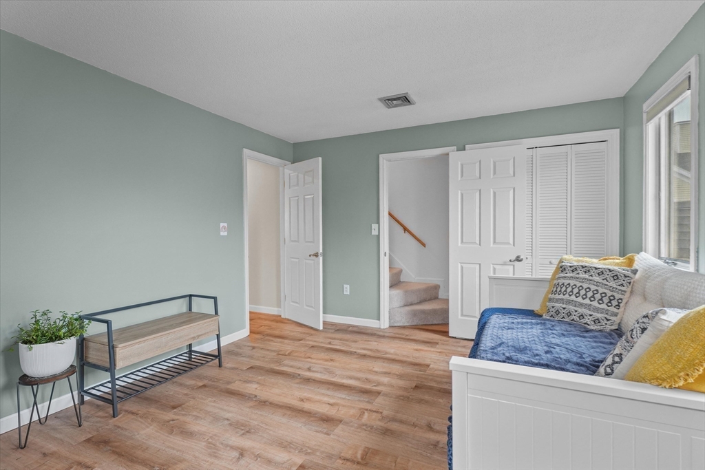 37 Constitution Lane, Unit 12 Danvers, MA 01923 - Photo 24 of 38 a living room with furniture and a potted plant