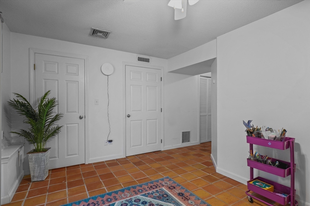 37 Constitution Lane, Unit 12 Danvers, MA 01923 - Photo 31 of 38 a bedroom with a bed and a potted plant