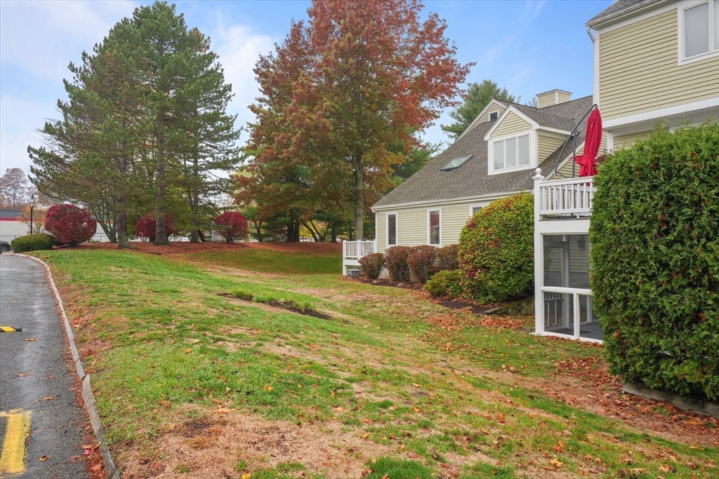 37 Constitution Lane, Unit 12 Danvers, MA 01923 - Photo 36 of 38 a front view of house with yard and green space