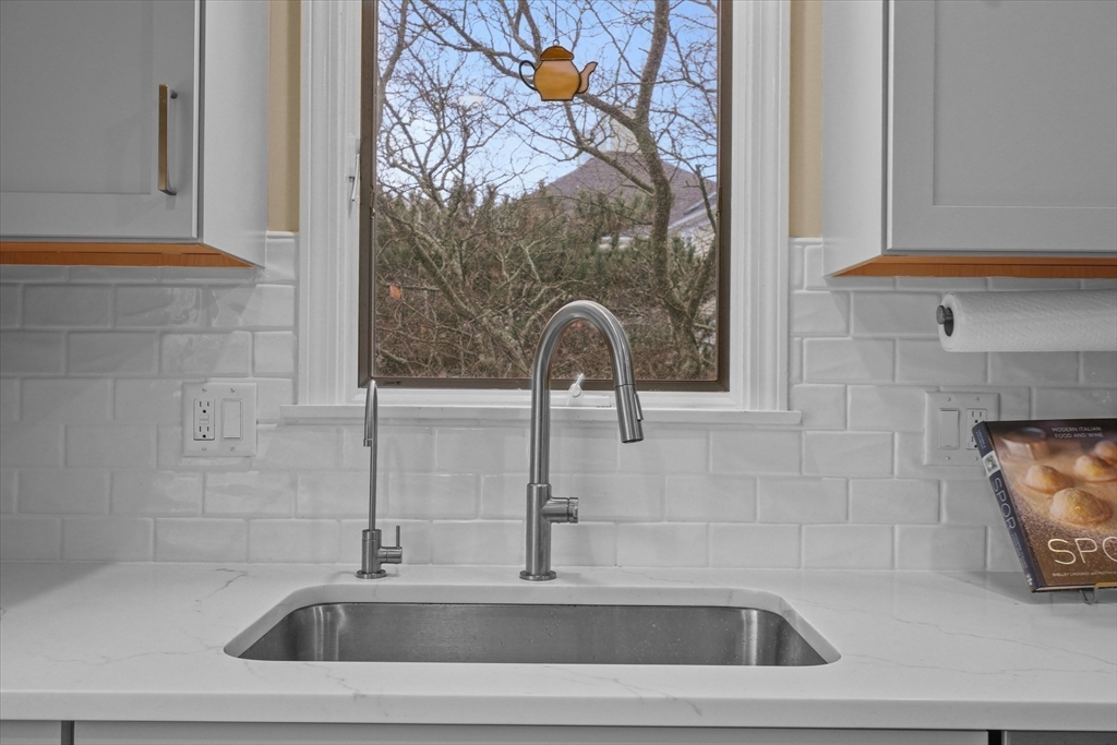 37 Constitution Lane, Unit 12 Danvers, MA 01923 - Photo 7 of 38 a bathroom with a sink and a mirror