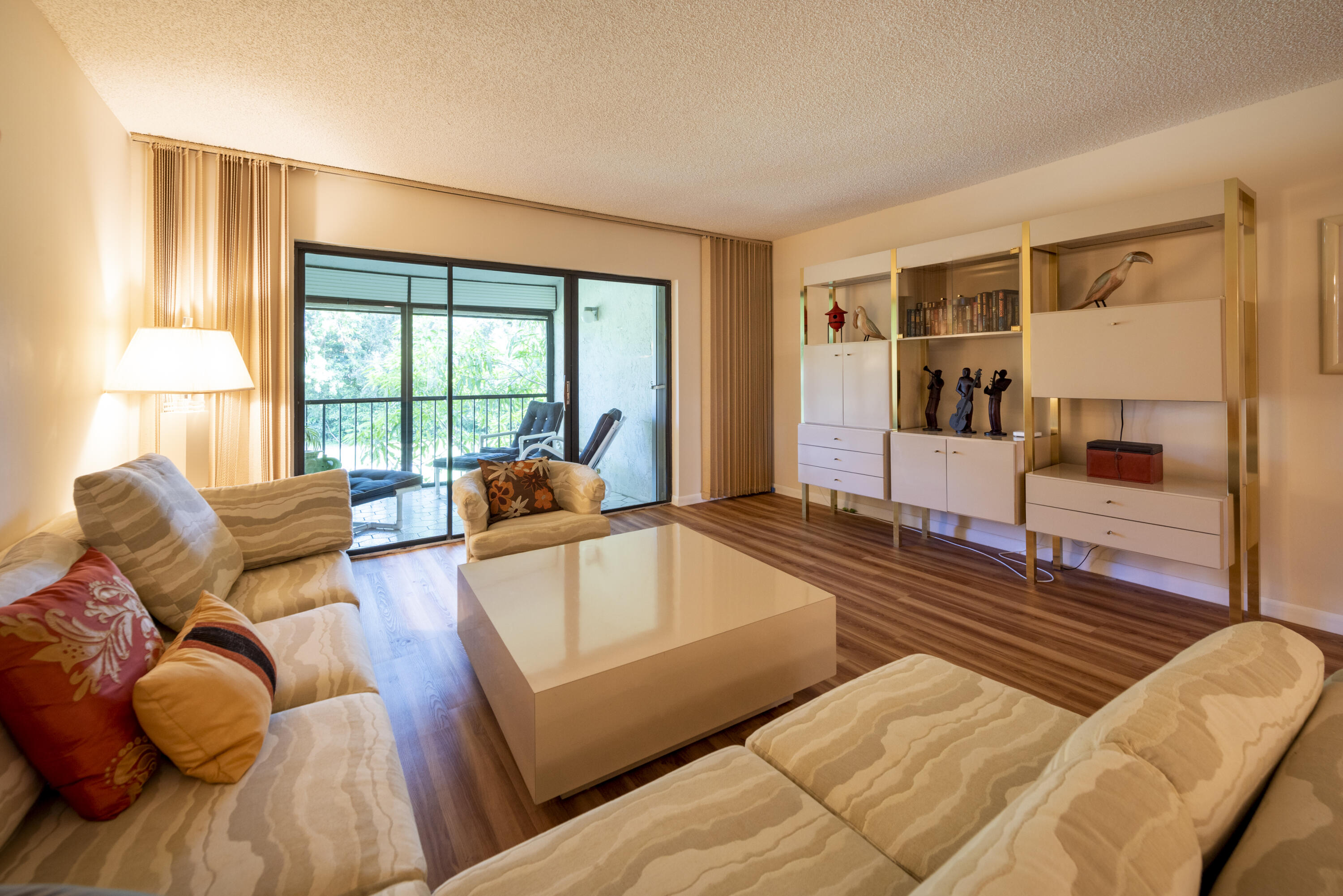9199 Pecky Cypress Lane, Unit 7F Boca Raton, FL 33428 - Photo 11 of 20 a living room with furniture and a large window