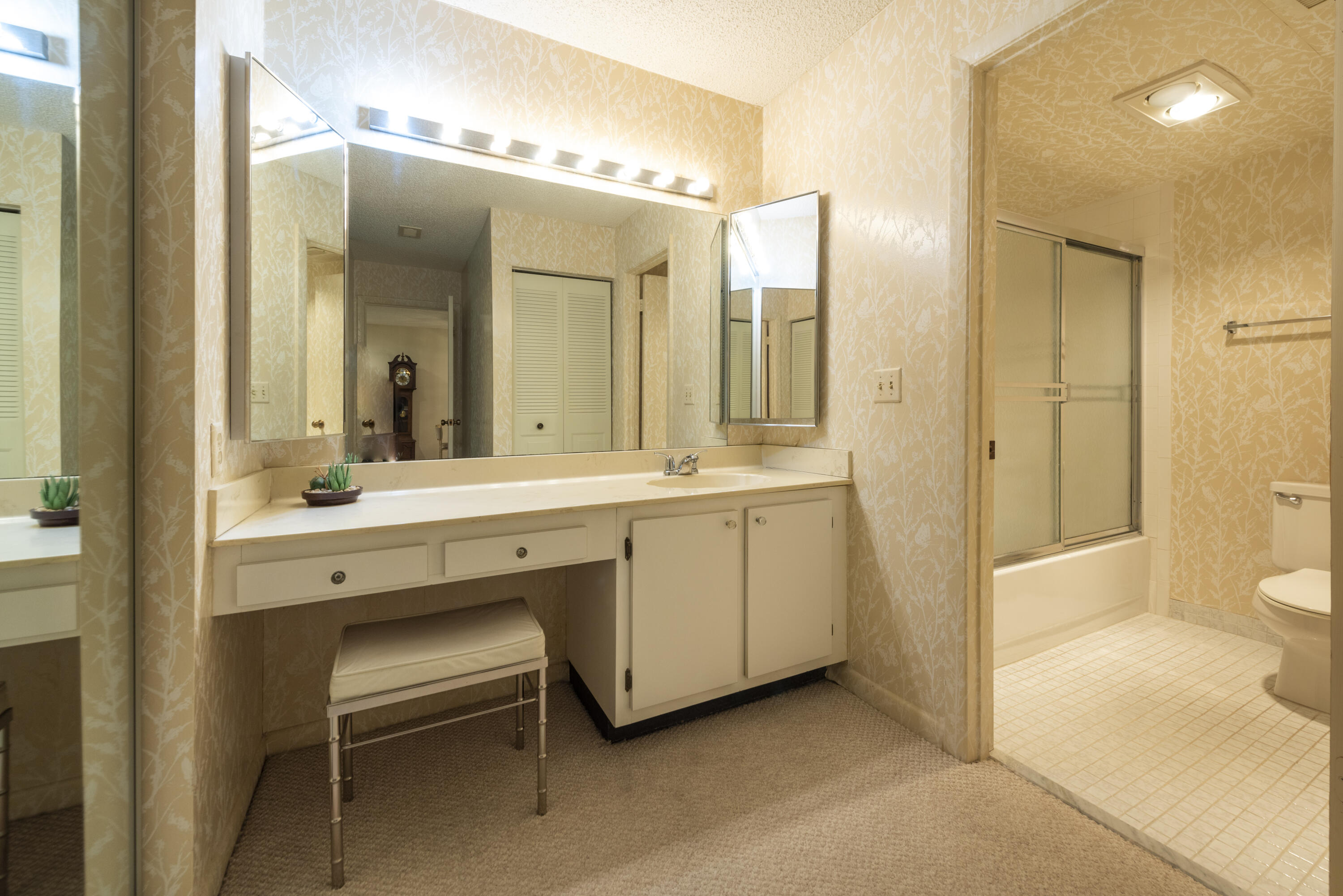 9199 Pecky Cypress Lane, Unit 7F Boca Raton, FL 33428 - Photo 15 of 20 a bathroom with a double vanity sink mirror and toilet