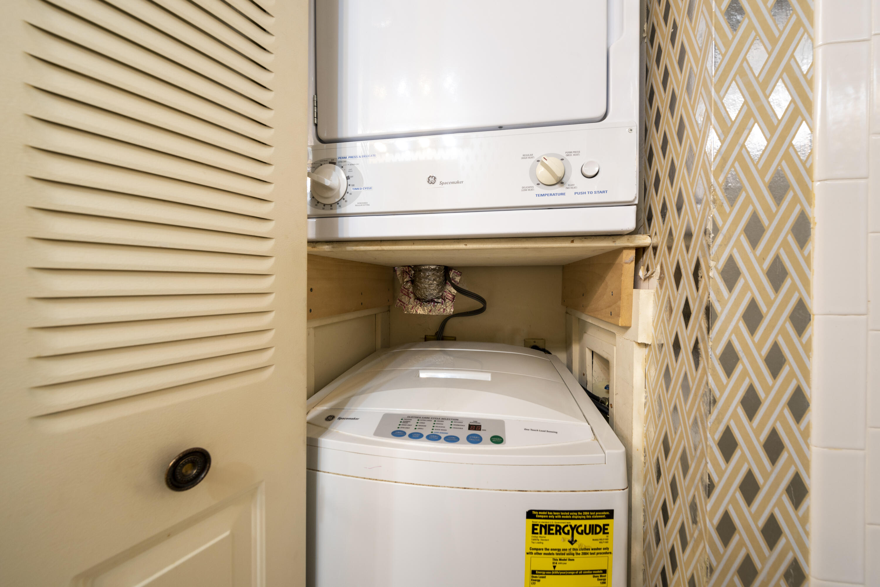 9199 Pecky Cypress Lane, Unit 7F Boca Raton, FL 33428 - Photo 19 of 20 a utility room with dryer and washer