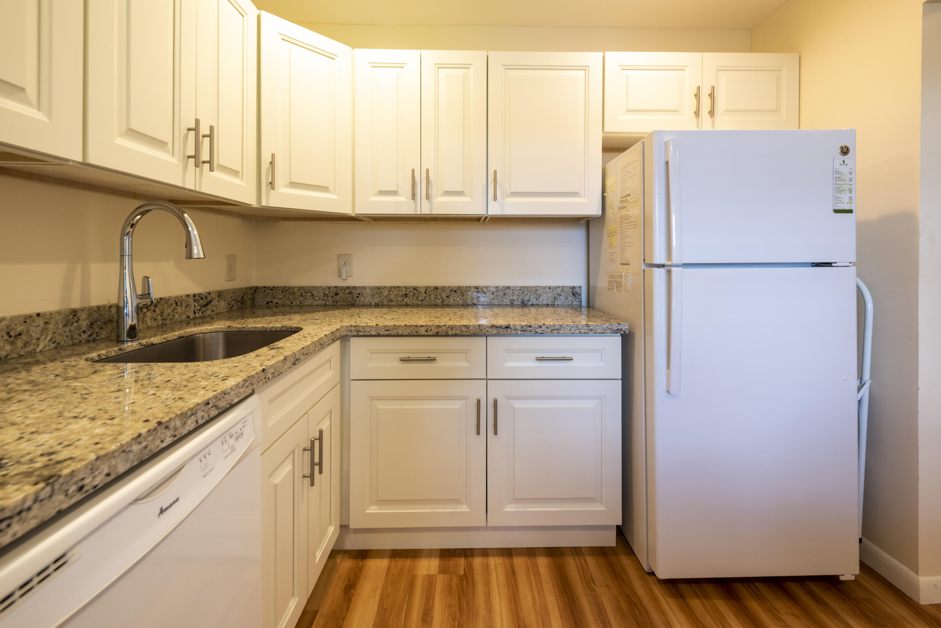 9199 Pecky Cypress Lane, Unit 7F Boca Raton, FL 33428 - Photo 5 of 20 a kitchen with granite countertop cabinets and refrigerator