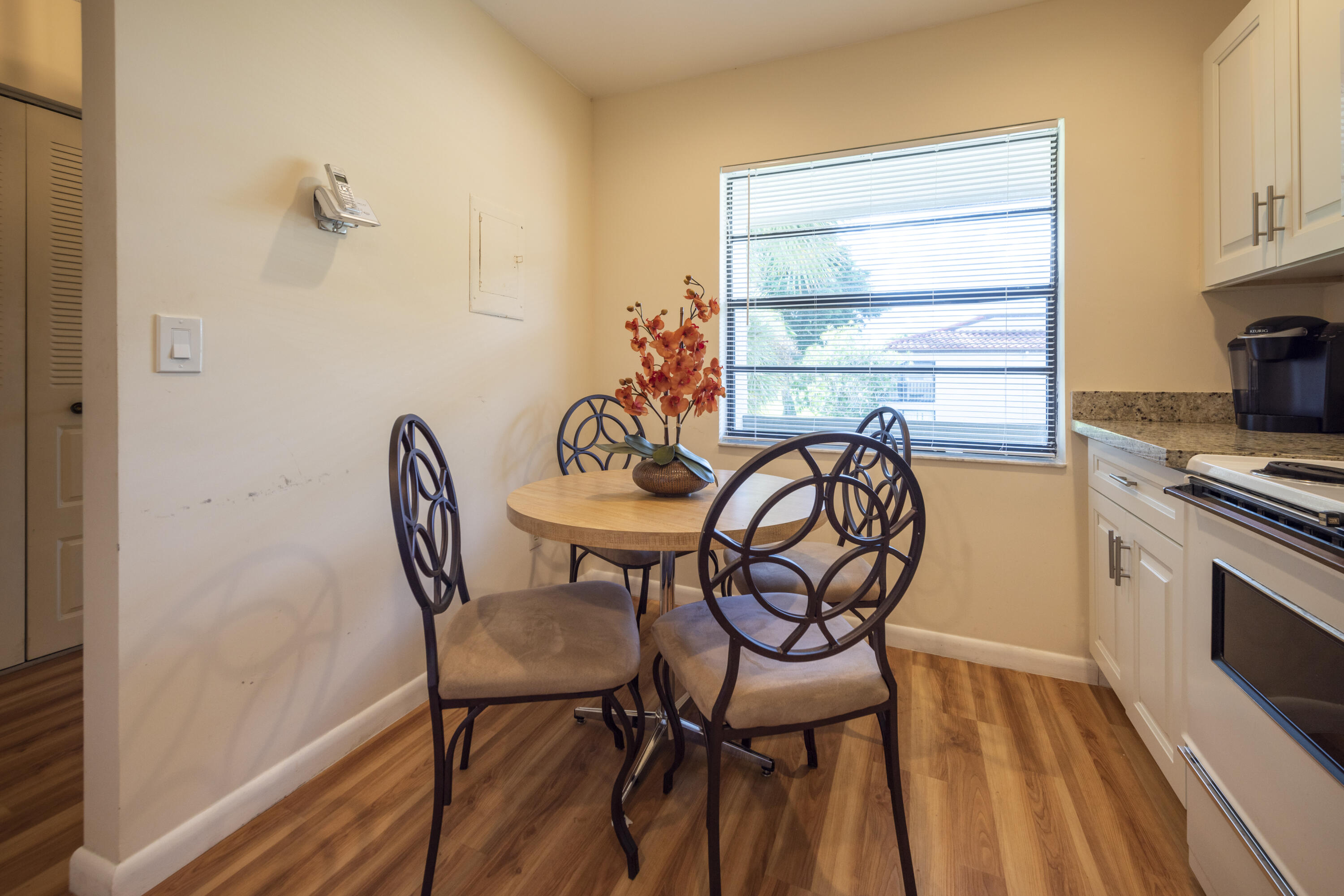 9199 Pecky Cypress Lane, Unit 7F Boca Raton, FL 33428 - Photo 6 of 20 a view of a dining room with furniture window and outside view