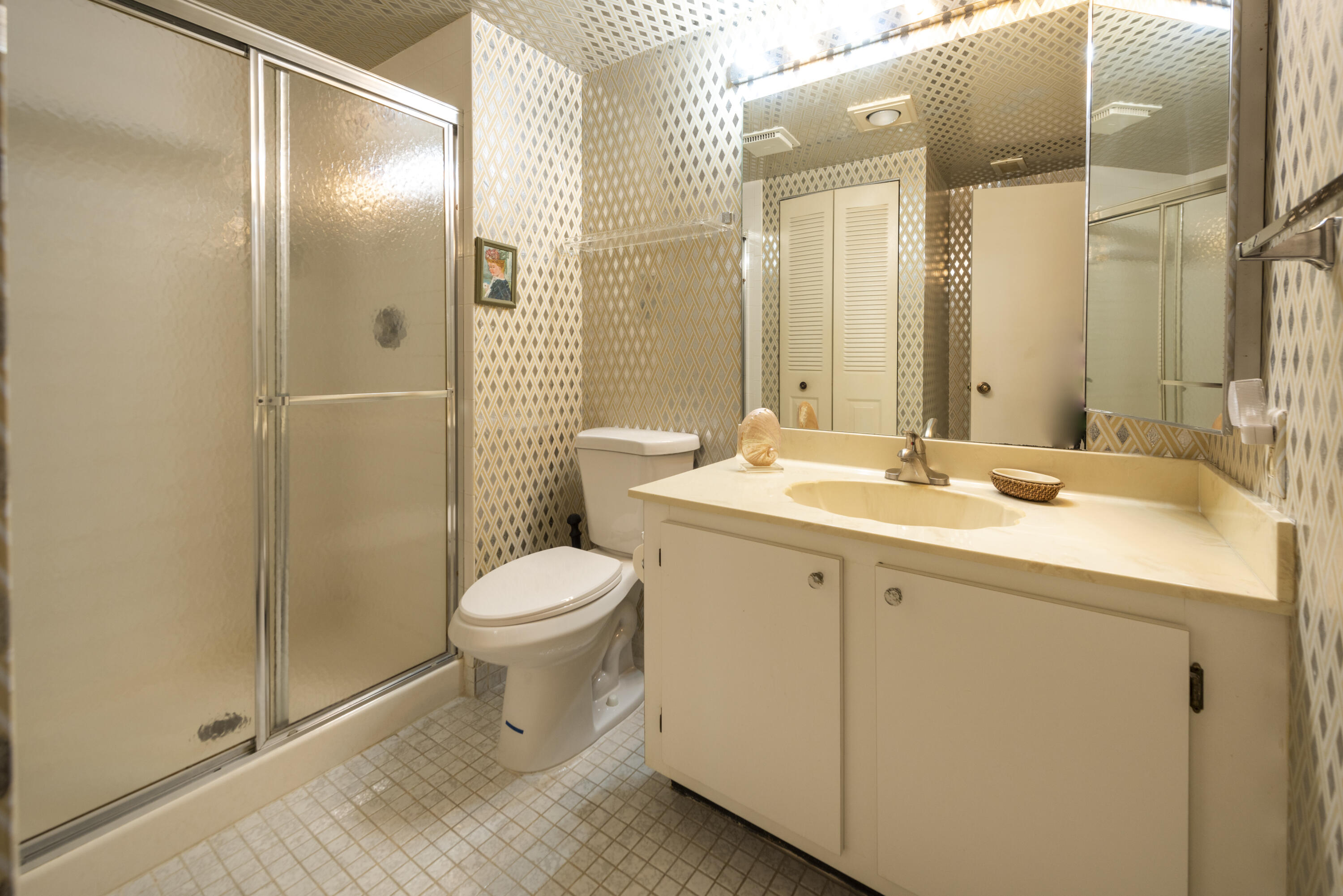 9199 Pecky Cypress Lane, Unit 7F Boca Raton, FL 33428 - Photo 7 of 20 a bathroom with a double vanity sink toilet and shower