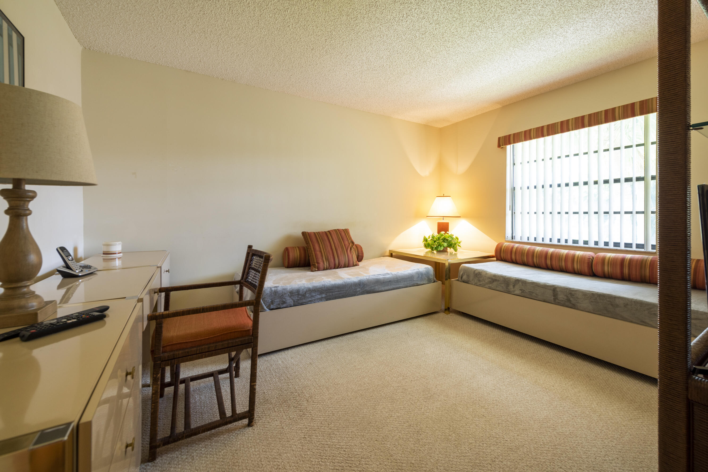 9199 Pecky Cypress Lane, Unit 7F Boca Raton, FL 33428 - Photo 8 of 20 a bedroom with furniture and a window