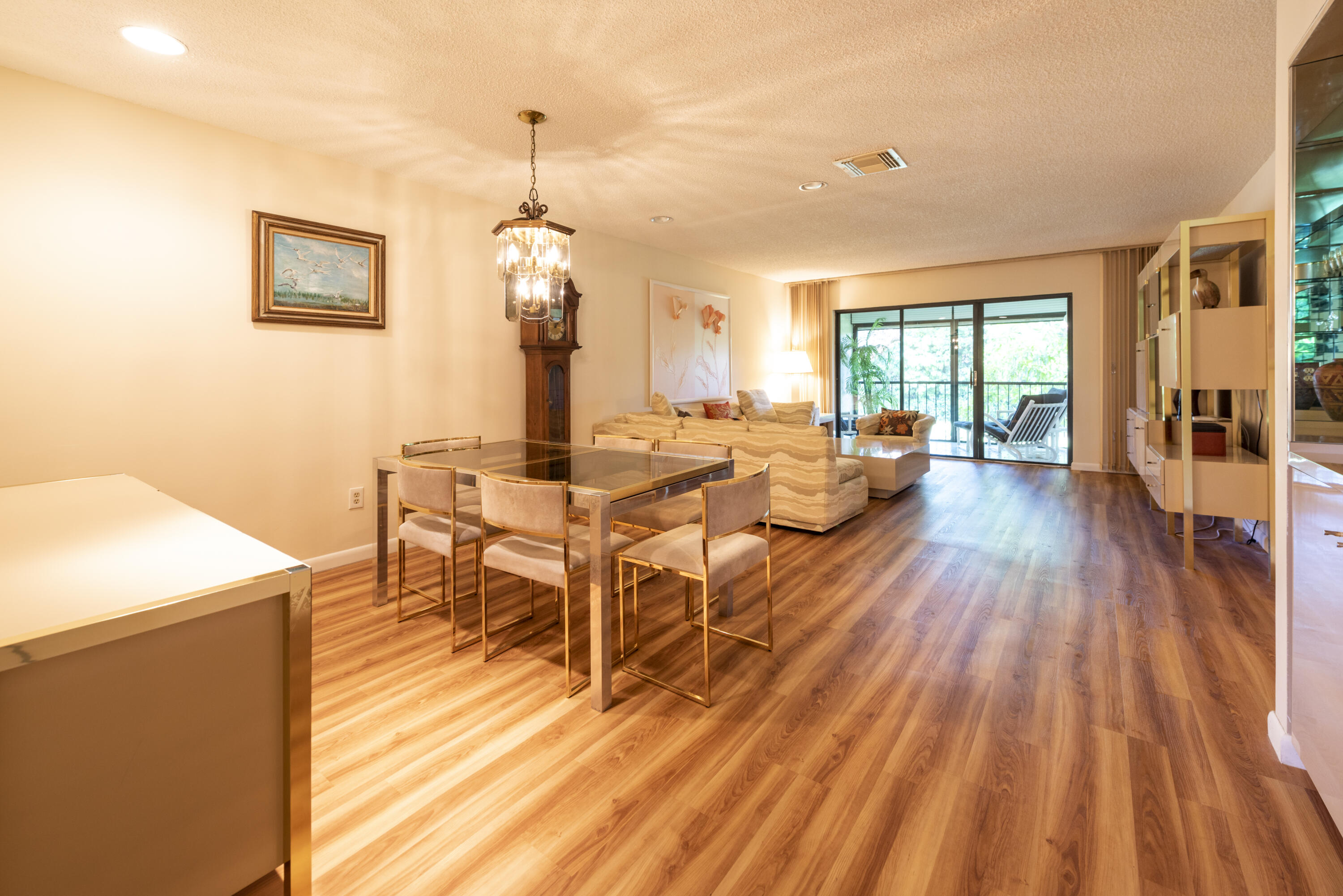 9199 Pecky Cypress Lane, Unit 7F Boca Raton, FL 33428 - Photo 9 of 20 a view of a dining room with furniture window and wooden floor