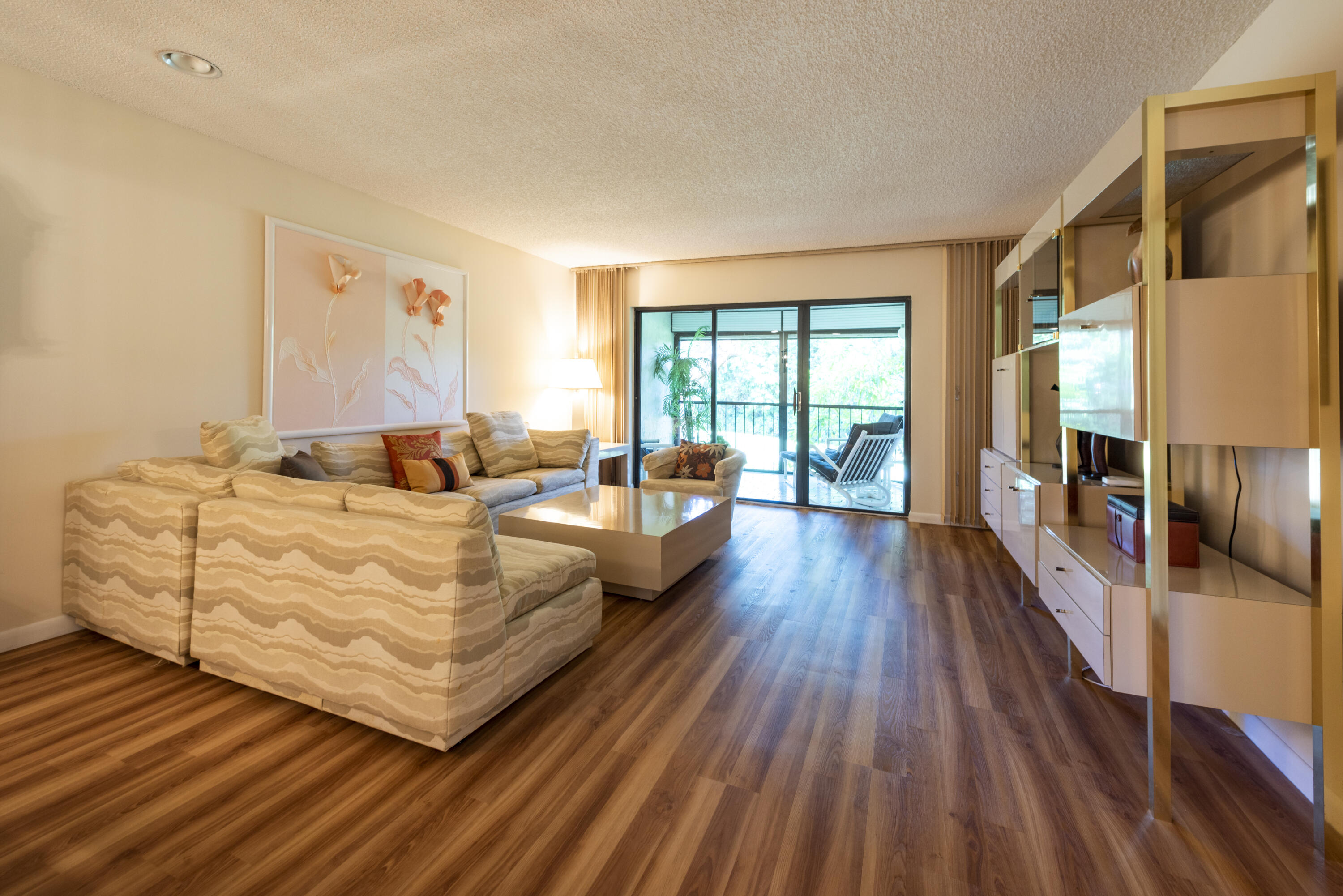 9199 Pecky Cypress Lane, Unit 7F Boca Raton, FL 33428 - Photo 10 of 20 a living room with furniture and a wooden floor