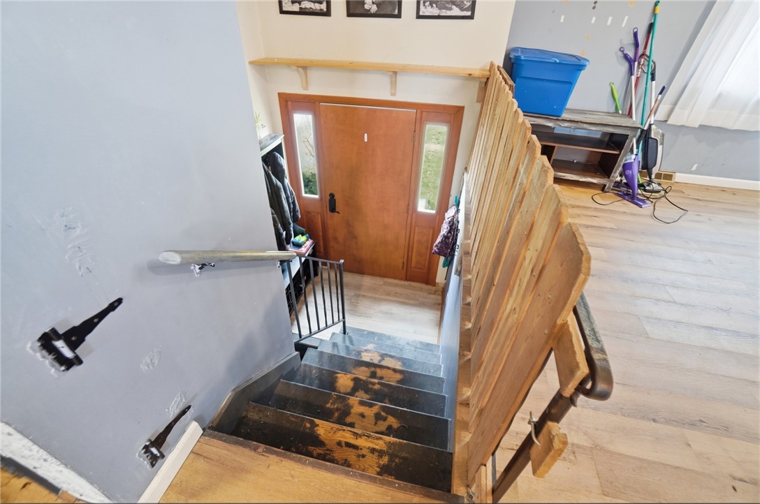 290 Ginghamsburg Road Tipp City, OH 45371 - Photo 5 of 49 This entry with wood flooring and staircase offers a welcoming entrance to the home.
