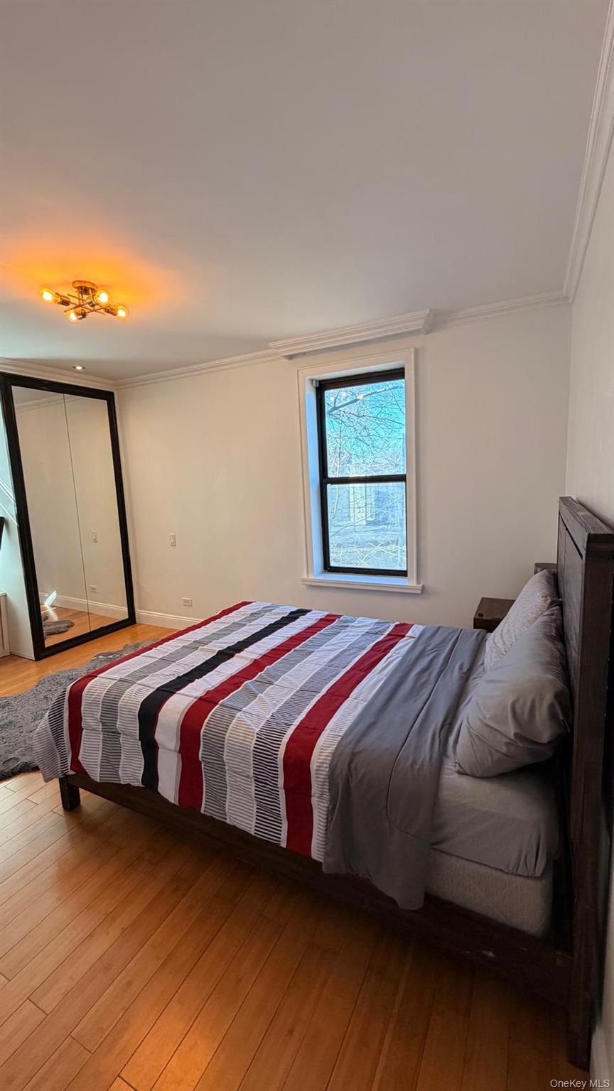8305 98th Street, Unit 3C Queens, NY 11421 - Photo 5 of 19 a bedroom with a bed and window