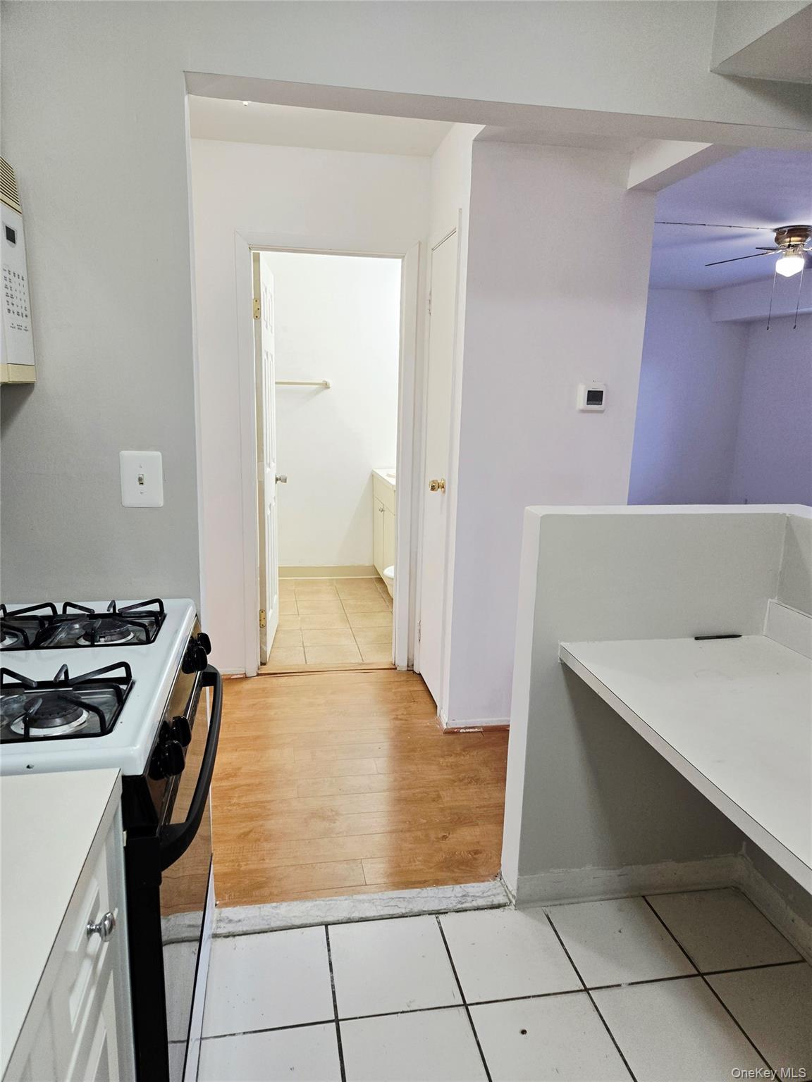 79 Pointe Circle South, Unit 79 Coram, NY 11727 - Photo 13 of 39 Kitchen featuring gas stove, light tile patterned flooring, light countertops, and ceiling fan
