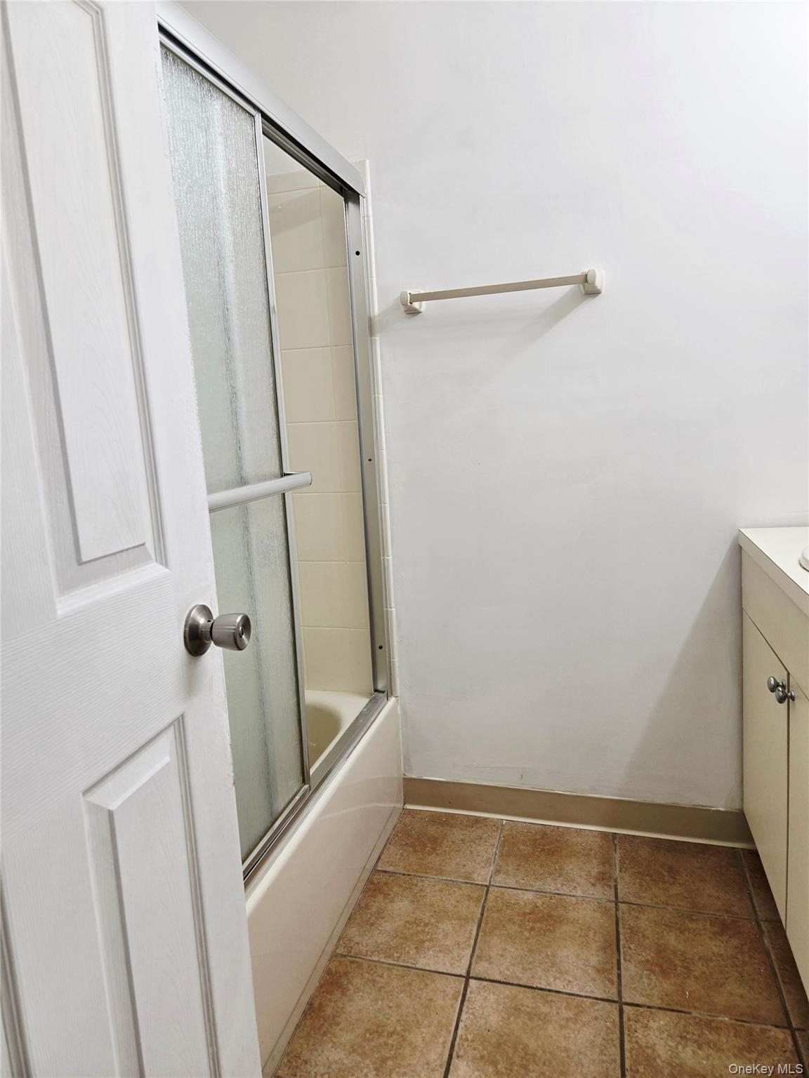 79 Pointe Circle South, Unit 79 Coram, NY 11727 - Photo 16 of 39 Full bath with vanity, enclosed tub / shower combo, and light tile patterned floors