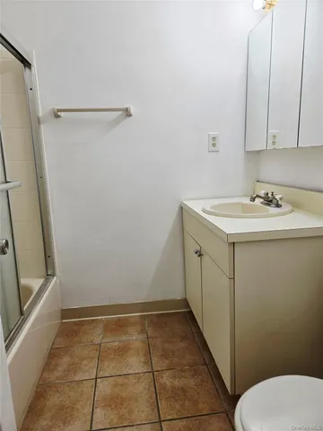 a bathroom with a sink a toilet and a shower