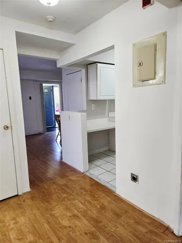 a view of a room with wooden floor and a window