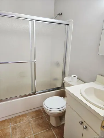 a white toilet sitting next to a bathroom sink