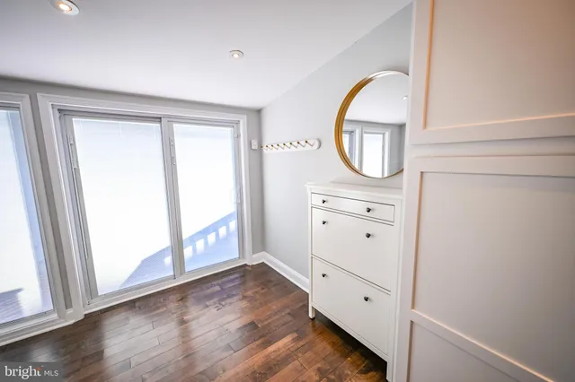 a view of an entryway with wooden floor