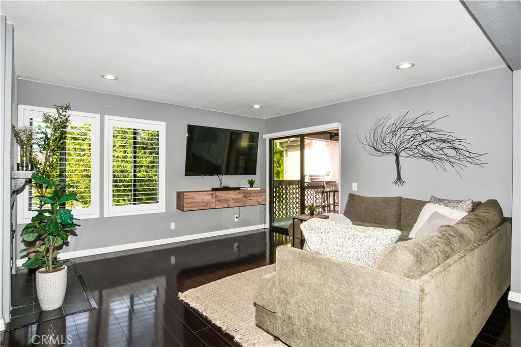 16551 Grunion Lane, Unit 204 Huntington Beach, CA 92649 - Photo 18 of 45 a living room with furniture and a flat screen tv