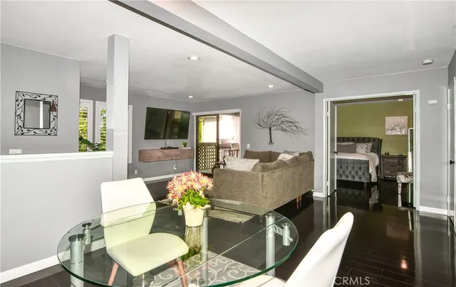 a bedroom with a bed and a flat screen tv in the kitchen