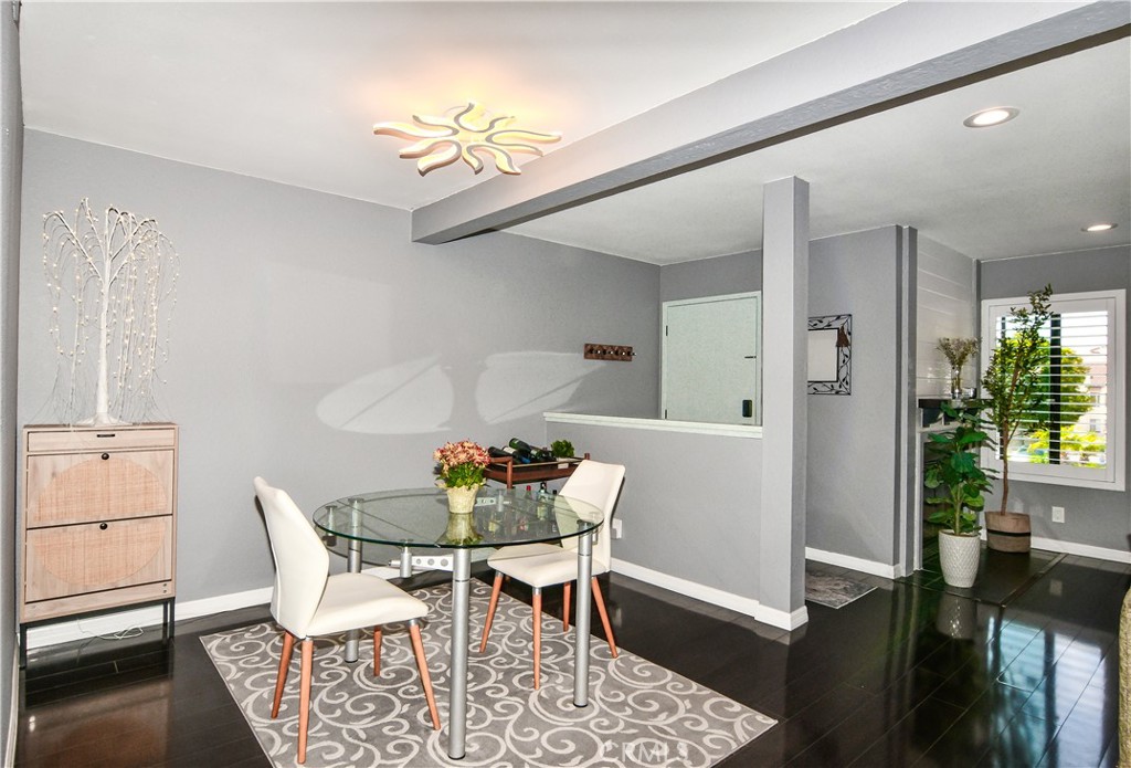16551 Grunion Lane, Unit 204 Huntington Beach, CA 92649 - Photo 22 of 45 a view of a dining room with furniture and wooden floor