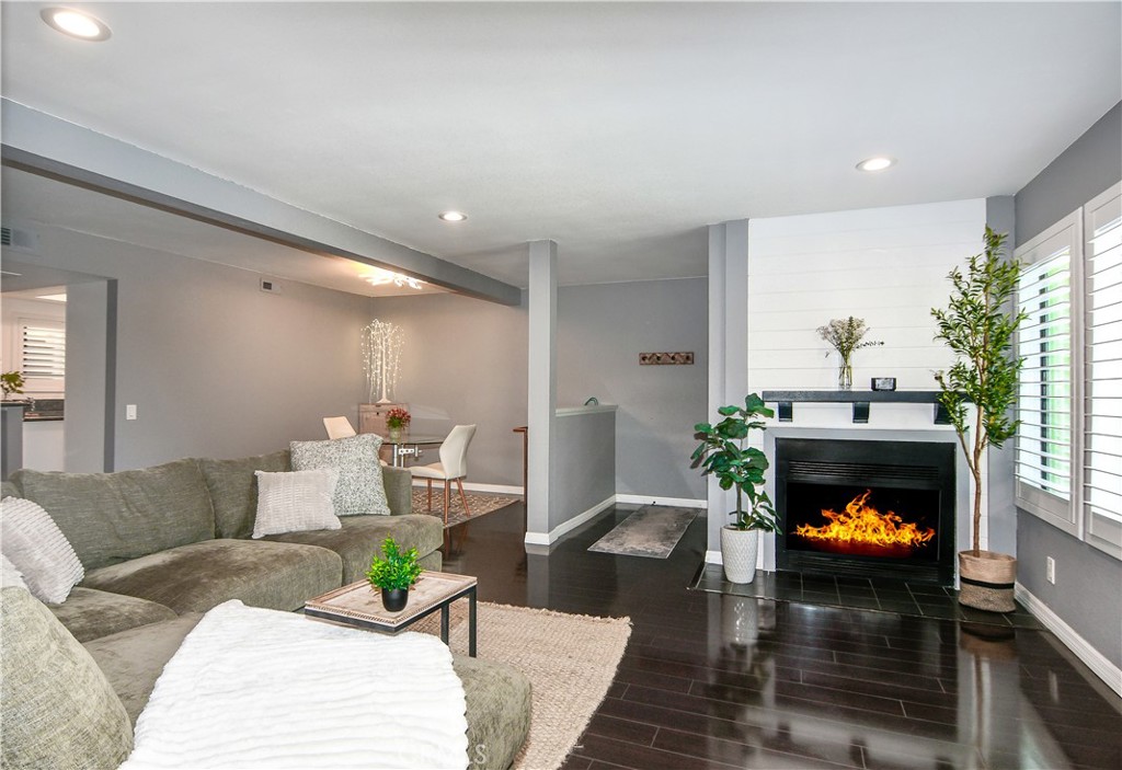 16551 Grunion Lane, Unit 204 Huntington Beach, CA 92649 - Photo 23 of 45 a living room with furniture and a fireplace