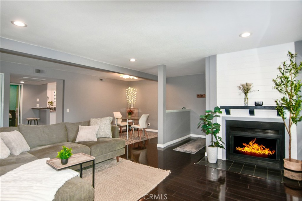 16551 Grunion Lane, Unit 204 Huntington Beach, CA 92649 - Photo 25 of 45 a living room with furniture and a fireplace