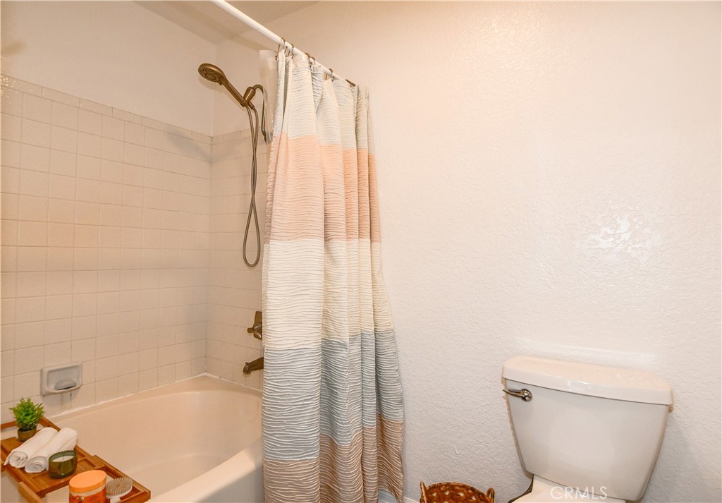 16551 Grunion Lane, Unit 204 Huntington Beach, CA 92649 - Photo 33 of 45 a bathroom with a toilet and a bathtub