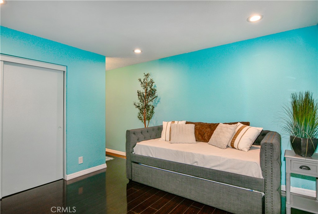 16551 Grunion Lane, Unit 204 Huntington Beach, CA 92649 - Photo 36 of 45 a bed sitting in a bedroom next to a window