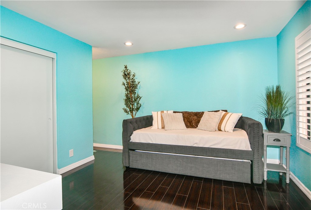 16551 Grunion Lane, Unit 204 Huntington Beach, CA 92649 - Photo 38 of 45 a bedroom with a bed and a potted plant