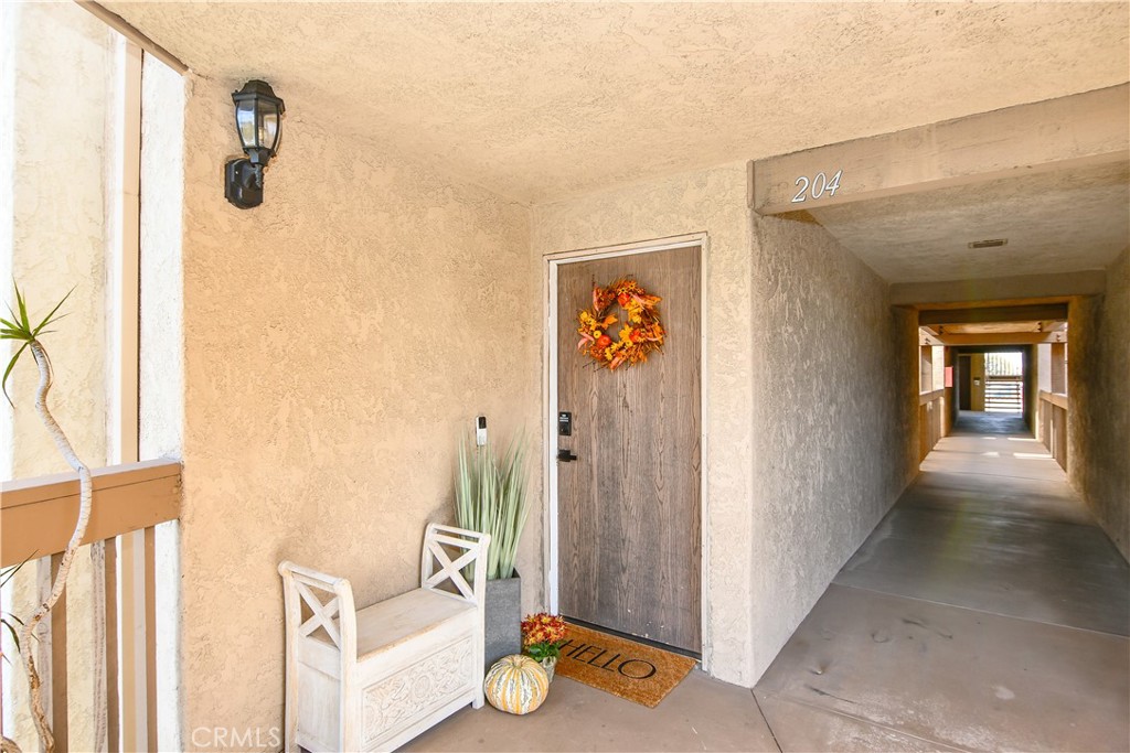 16551 Grunion Lane, Unit 204 Huntington Beach, CA 92649 - Photo 6 of 45 a view of hallway with livingroom and couch