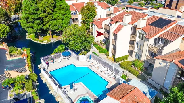 a kitchen with granite countertop a refrigerator and a sink