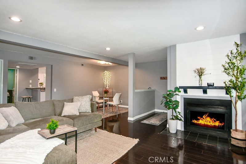 16551 Grunion Lane, Unit 204 Huntington Beach, CA 92649 - Photo 9 of 45 a living room with furniture and a fireplace