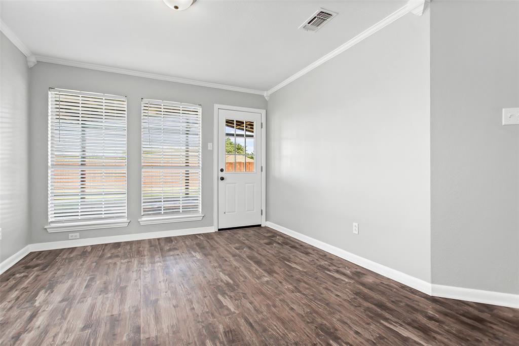 712 Billups Street Van Alstyne, TX 75495 - Photo 14 of 38 a view of an empty room with wooden floor and a window