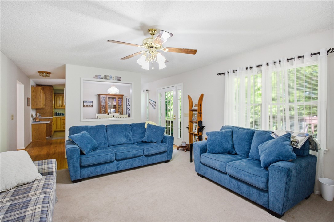 110 Snug Harbor Road Seneca, SC 29678 - Photo 6 of 37 This bright living area features carpet flooring and convenient access to the kitchen and outdoor space.