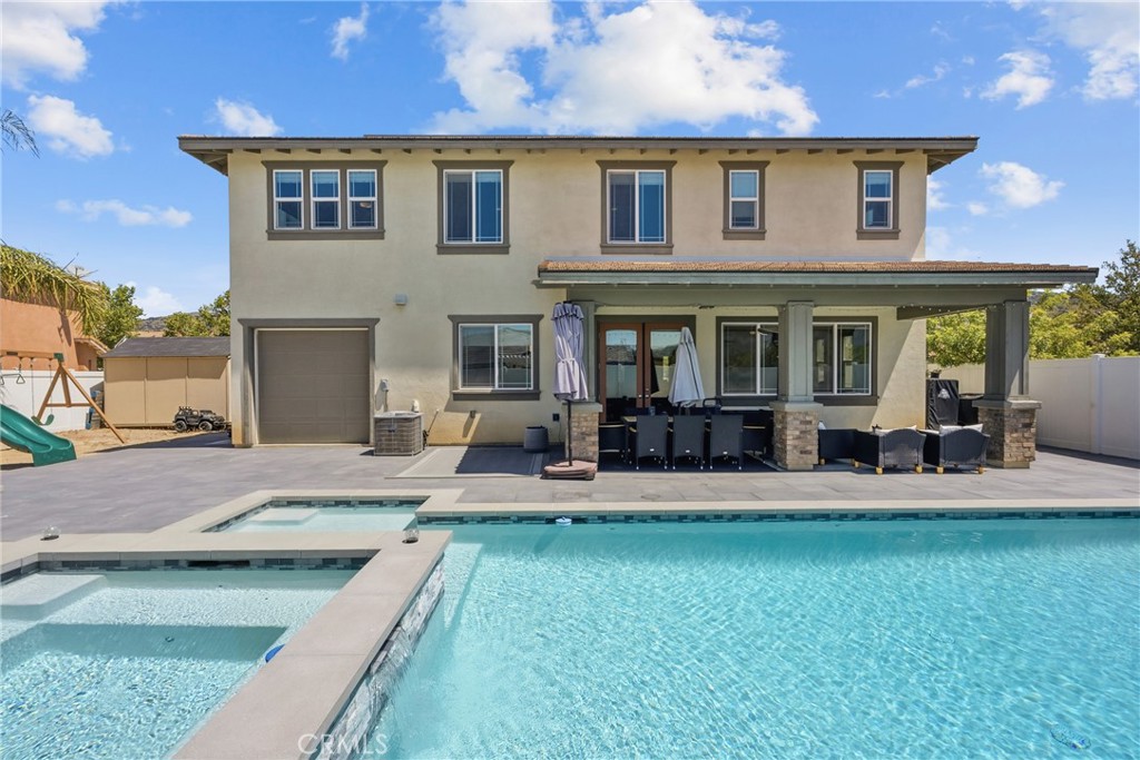 232 River Street Fillmore, CA 93015 - Photo 47 of 61 Exceptional outdoor entertaining space featuring a sparling poo, cozy firepit, ample seating areas, and a wood-burning-fireplace, perfect for or hosting gatherings year-round