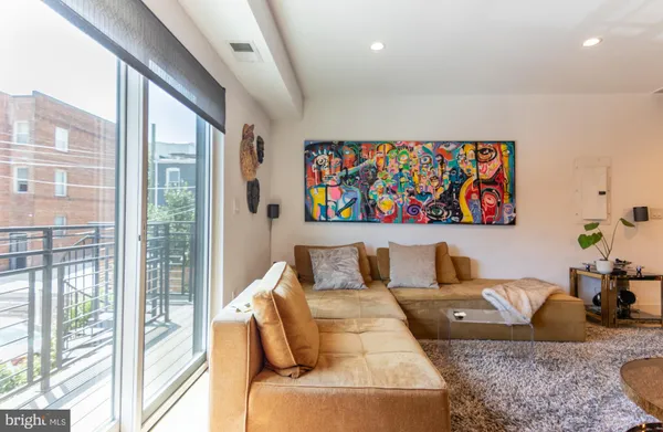 a living room with furniture large window and a flat screen tv