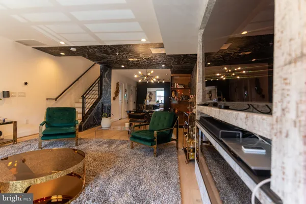 a living room with table chairs and a stove