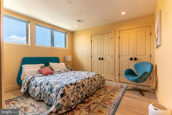 a bedroom with a bed a table and chair